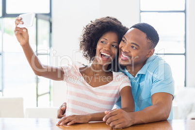 Happy couple taking a selfie on phone