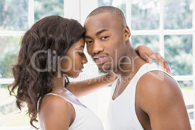 Young couple standing face to face and hugging each other