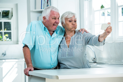 Retired couple making faces
