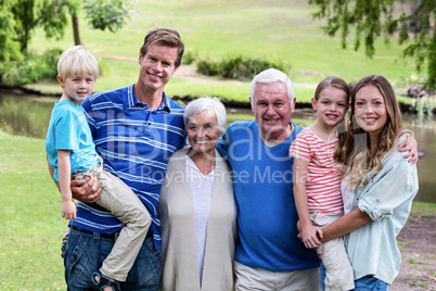 Multi-generation family standing in the park