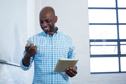 Man using digital tablet and mobile phone