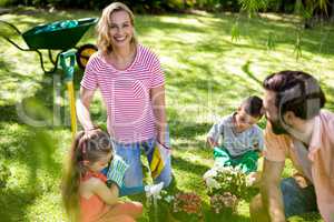 Woman with family during gardening in yard