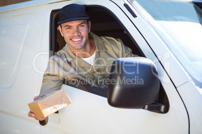 Smiling delivery man sitting in his van Smiling delivery man sitting in his van
