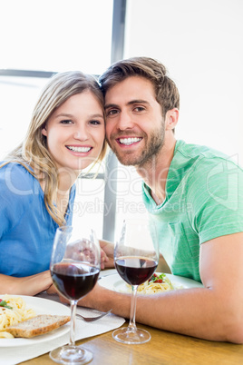 Young couple sitting together while having meal