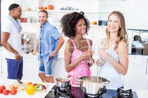 Friends having wine in kitchen