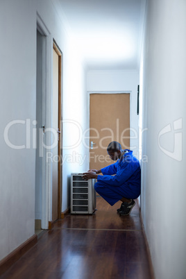 Handyman testing air conditioner