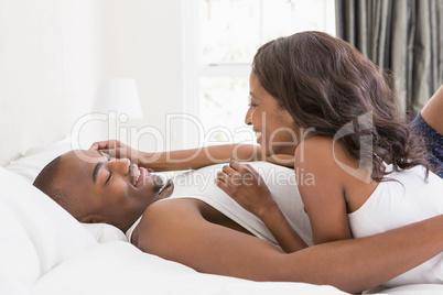 Young couple cuddling in the bedroom