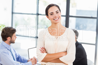 Pretty businesswoman smiling with arms crossed