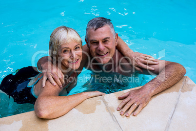 Senior couple swimming in pool