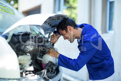 Side view of technician repairing van