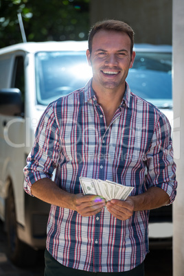 Young man counting currency notes