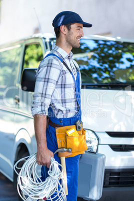 Side view of happy carpenter with toolbox