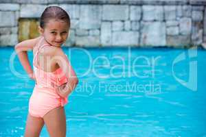 Portrait of girl standing at poolside