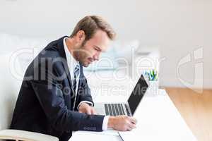 Businessman using laptop at desk