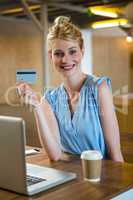 Beautiful woman showing credit card