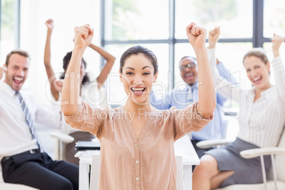 Portrait of businesswoman celebrating success with her colleague