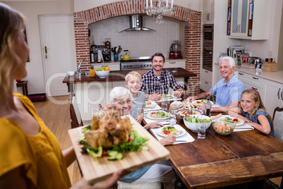 Woman holding a tray of roasted turkey