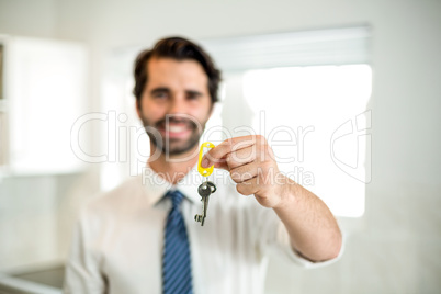 Confident businessman showing key