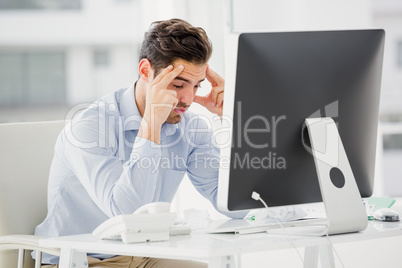 Businessman using laptop and taking notes