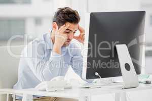 Businessman using laptop and taking notes