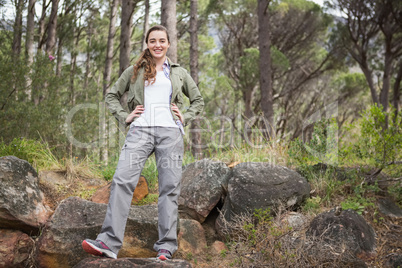 Smiling woman with hands on her hips