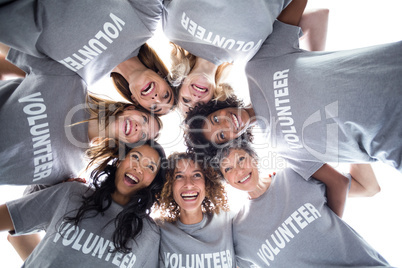 Happy volunteers forming a huddle