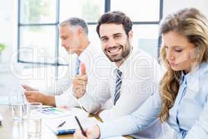 Portrait of businessman showing thumbs up