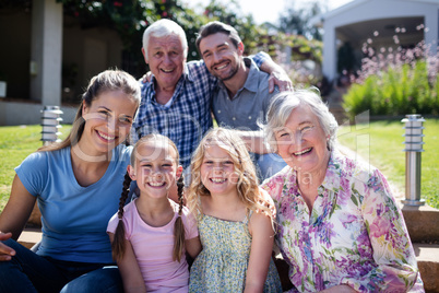 Multi-generation family sitting in the garden