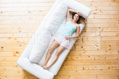 Young woman relaxing on sofa