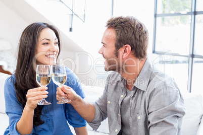 Young couple toasting wine glasses