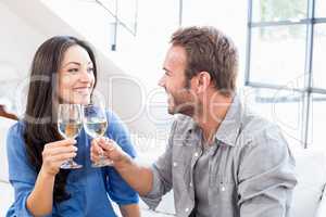 Young couple toasting wine glasses