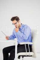 Businessman looking at document and using digital tablet