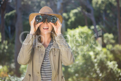 Smiling woman using binoculars