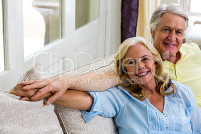 Romantic senior couple sitting in living room at home