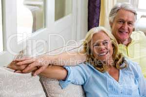 Romantic senior couple sitting in living room at home