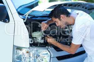 Side view of mechanic repairing van