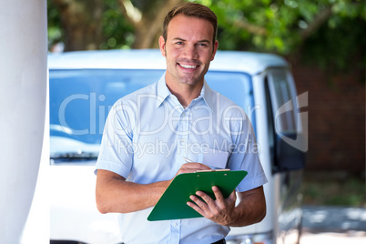 Handyman standing near his delivery van