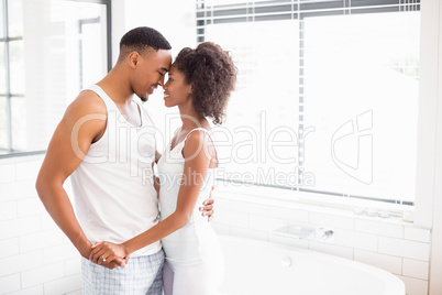 Young couple embracing each other in bathroom