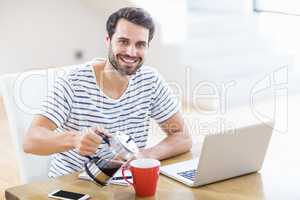 Man pouring coffee in a coffee mug at home