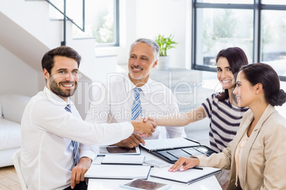 Businessmen shaking hands with businesswomen