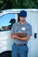 Delivery person writing in clipboard