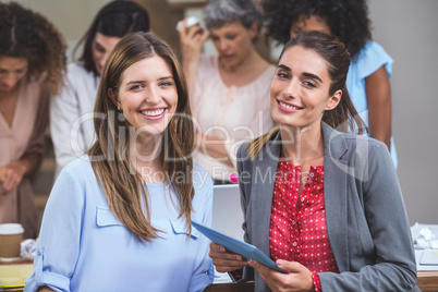 Portrait of two interior designers with digital tablet