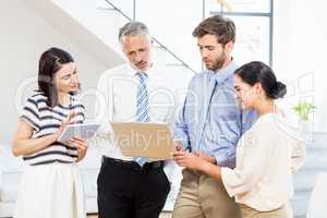 Business people interacting using digital tablet and laptop