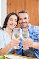 Young couple toasting wine glasses