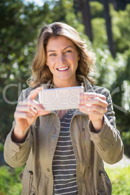 Smiling woman taking selfie