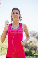 Woman jogging while listening to music