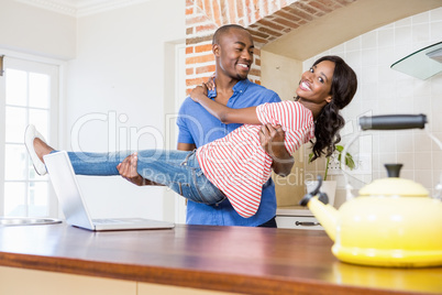 Young man carrying woman in his arms