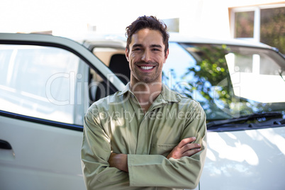 Smiling pesticide worker with arms crossed