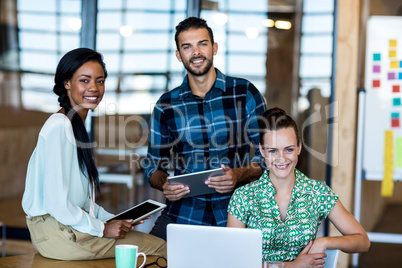 Young man and women sitting at their desk