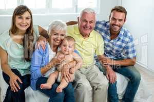 Happy multi-generation family on bed at home